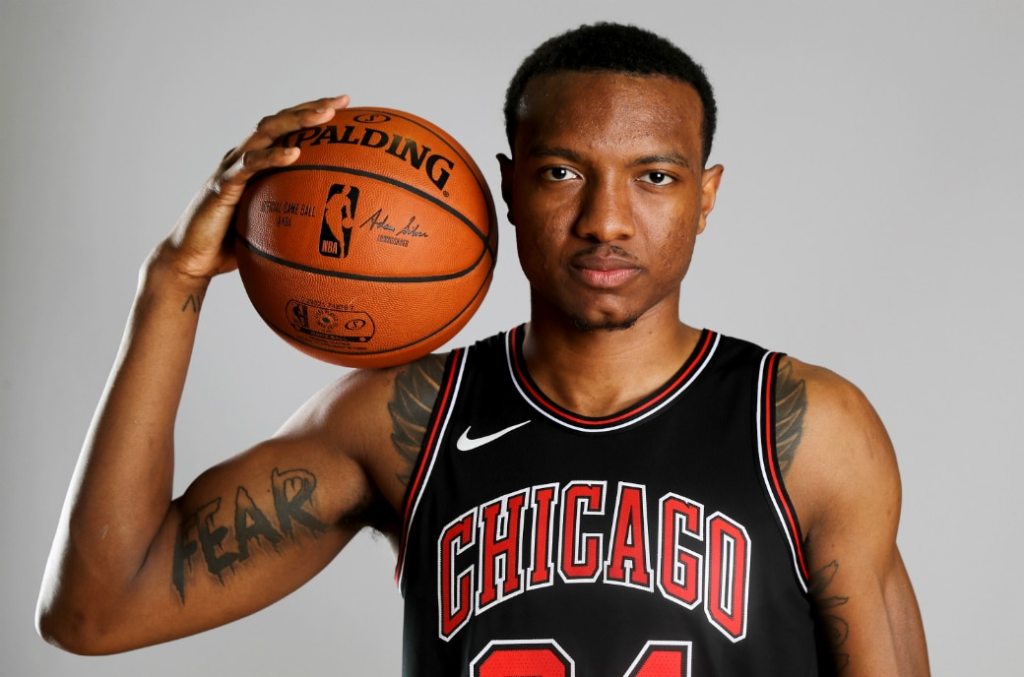 Wendell Carter Jr. with a basketball on his shoulder.